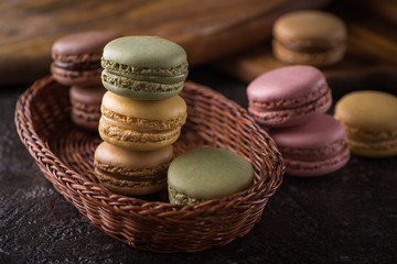 Columns with macaroons on wicker basket background