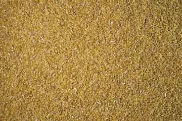 Crushed wheat groats background texture