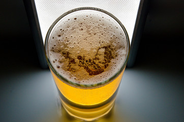 glass of beer on dark background,glass of cold beer on the table. object on a black background, а glass of beer, alcohol beverages, beer with foam  black background