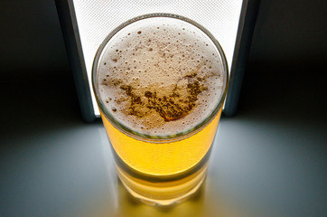 glass of beer on dark background,glass of cold beer on the table. object on a black background, а glass of beer, alcohol beverages, beer with foam  black background
