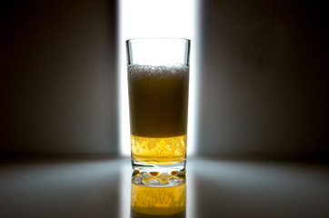 glass of beer on dark background,glass of cold beer on the table. object on a black background, а glass of beer, alcohol beverages, beer with foam  black background