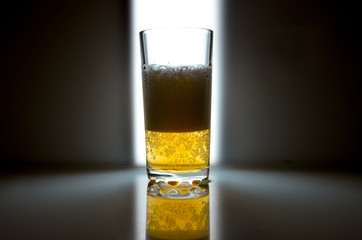 glass of beer on dark background,glass of cold beer on the table. object on a black background, а glass of beer, alcohol beverages, beer with foam  black background
