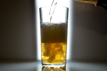 glass of beer on dark background,glass of cold beer on the table. object on a black background, а glass of beer, alcohol beverages, beer with foam  black background