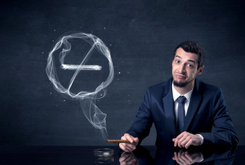 Businessman smoking cigarette and the smoke forms a no smoking sign.