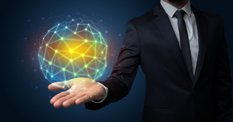 Businessman in suit holding global connection symbol on his hand
