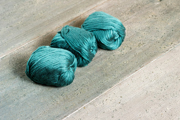 green balls of wool on old wood table