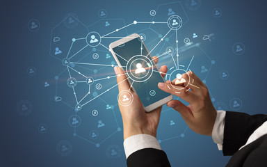 Female hand using smartphone to connect peoples all around the online surface
