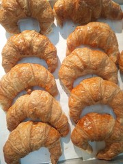 Breakfast bread croissant. Tasty fresh baking crusty croissant background . French pastry.Food and drink sandwich bread in morning time.
