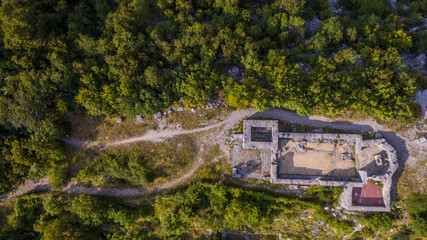 Aerial view on the ruins of a medieval church, historic site on the border between Italy and...