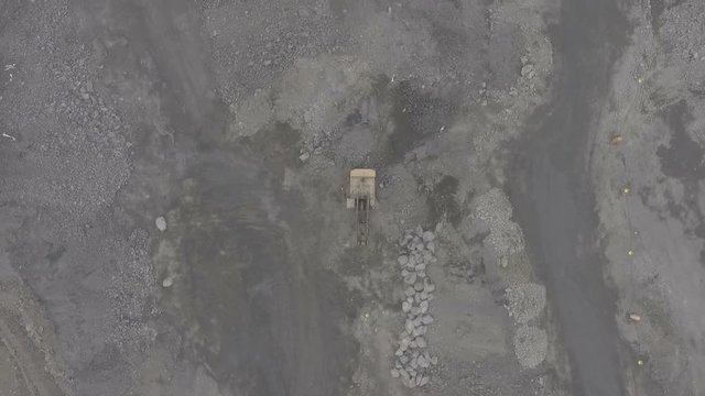 A huge ore quarry. Filming drone. Fly up.