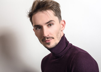 Obraz premium Handsome young elegant man in violet golf.