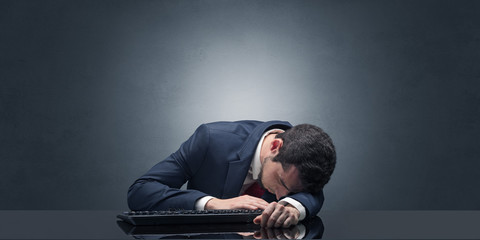 Young businessman fell asleep at his workplace with copy space