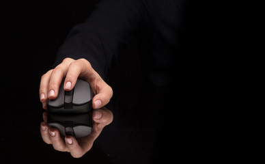 Hand using wireless mouse in a dark environment
