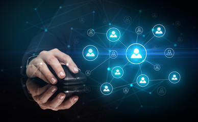 Hand using wireless mouse in a dark environment with human network concept