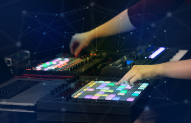 Obraz na płótnie Canvas Hand remixing music on midi controller with play music and multimedia concept 