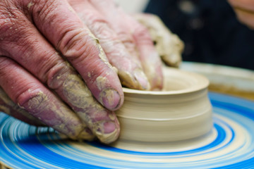 Street master class on modeling of clay on a potter's wheel In the pottery workshop