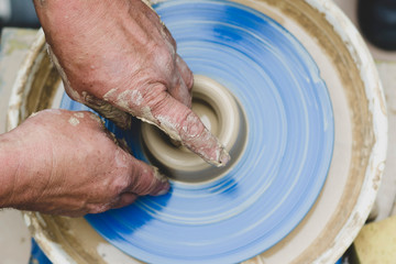 Street master class on modeling of clay on a potter's wheel In the pottery workshop