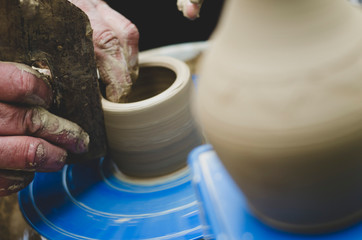 Potter at work. makes a jug out of clay. pottery workshop