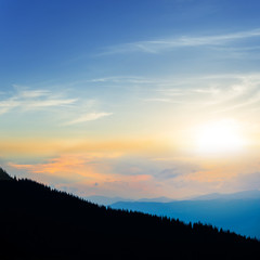 Naklejka na ściany i meble mount slope silhouette on the dramatic sunset background