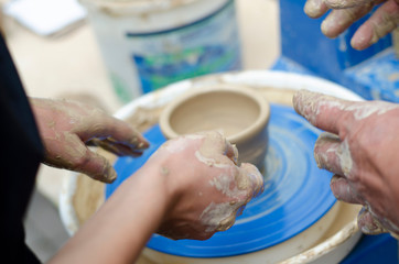 Street master class on modeling of clay on a potter's wheel In the pottery workshop