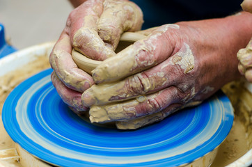 Street master class on modeling of clay on a potter's wheel In the pottery workshop
