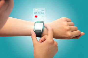 Female hand with smartwatch and running concept above.
