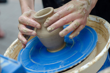 Street master class on modeling of clay on a potter's wheel In the pottery workshop