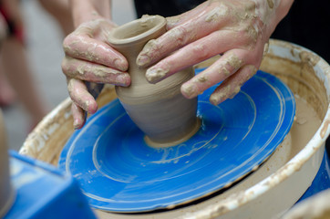 Street master class on modeling of clay on a potter's wheel In the pottery workshop