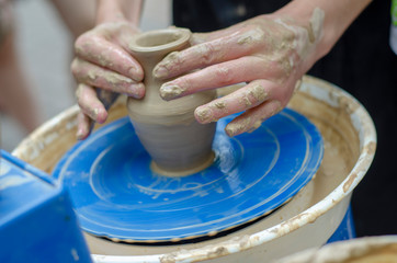 Street master class on modeling of clay on a potter's wheel In the pottery workshop