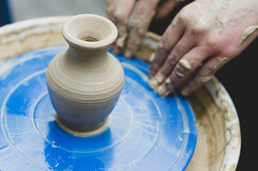 Street master class on modeling of clay on a potter's wheel In the pottery workshop
