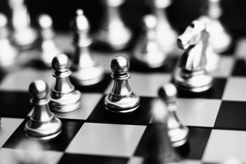 Chess board game, business competitive concept, pawn encounters disadvantage situation against...