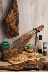 Smoked lamb leg with specialists on the wooden table