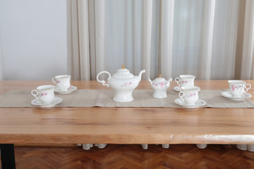 Fototapeta na wymiar Cups on wooden table