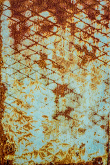 Texture of old rusty metal, painted white which became orange from rust. Vertical texture of rusty pattern on paint in form of steel net