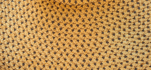 Weaving straws texture. Woven hat with pattern and texture. Close-up background top view