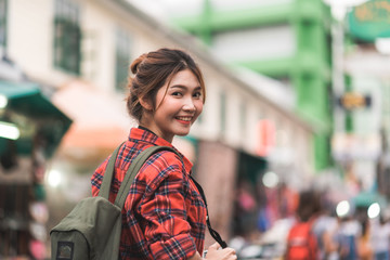 Fototapeta premium Traveler backpacker asian woman travel in Khao San road at Bangkok, Thailand. Happy young female spending holiday trip at amazing landmark and enjoy her journey in traditional city.