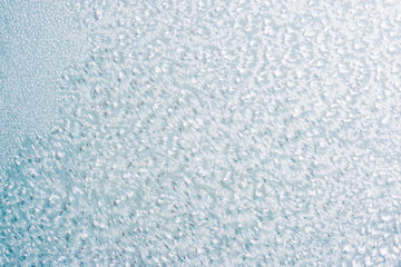 Frozen winter abstract background on the window glass with copy space