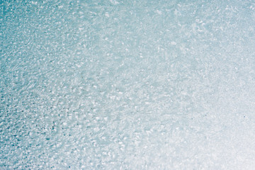 Frozen winter abstract background on the window glass with copy space