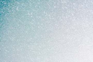Frozen winter abstract background on the window glass with copy space