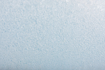 Winter background with gleaming ice. Frozen water texture. Copy space