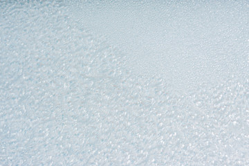 Winter background with gleaming ice. Frozen water texture. Copy space