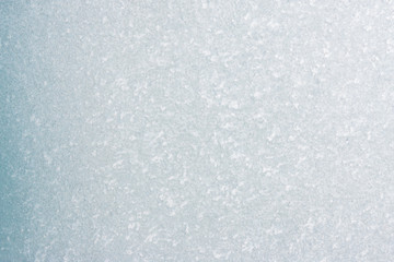 Obraz premium Winter background with gleaming ice. Frozen water texture. Copy space