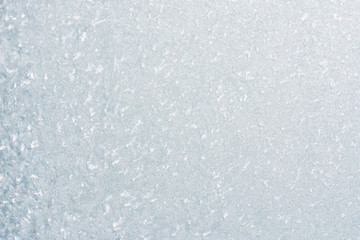 Winter background with gleaming ice. Frozen water texture. Copy space