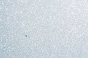 Winter background with gleaming ice. Frozen water texture. Copy space.