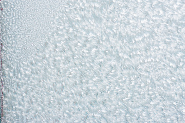 Ice background, frozen water with glass. Winter texture. Copy space.