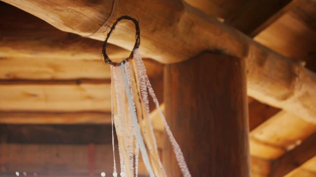 Authentic Boho Dreamcatcher as Decoration of a Rural Wooden Banquet Hall Fluttering in the Air