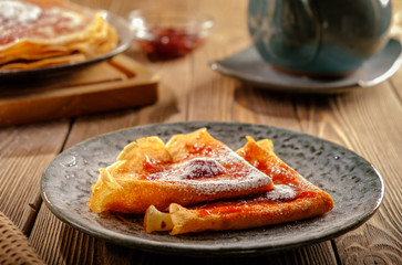 Pancakes with strawberry jam and lemon tea