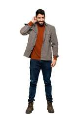 Fototapeta premium Full-length shot of Handsome man with beard having doubts on isolated white background