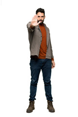 Naklejka premium Full-length shot of Handsome man with beard making stop gesture denying a situation that thinks wrong on isolated white background