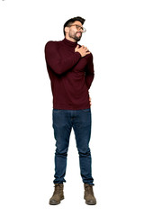Naklejka premium Full-length shot of Handsome man with glasses suffering from pain in shoulder for having made an effort on isolated white background